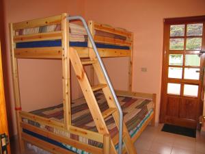 Etagenbett in einem Zimmer mit einer Leiter in der Unterkunft Atico Orion Fibra 600 Mb in Casa Nueva