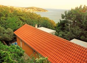 an orange house with an orange roof on a hill at Quercus Apartment in Stara Baška +14 photos