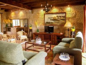 a living room with two couches and a tv at Casa Anceu ArchsenseApartments. in Anceu