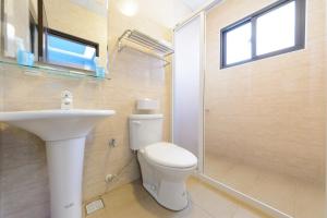 a bathroom with a toilet and a sink and a shower at Cat Mia Hostel in Hualien City