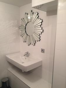 a bathroom with a sink and a mirror on the wall at Chalet Marmotte 3 in Morzine