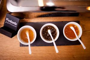 a group of three cups of coffee on a tray at Steindls Boutique Favourite in Vipiteno