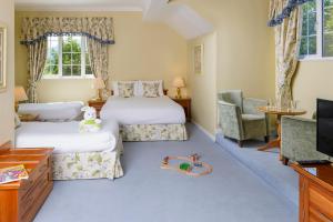 a bedroom with a bed and a chair at Old Weir Lodge in Killarney