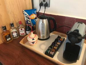 a coffeemaker sitting on top of a counter with a coffee maker at Pili Pili Boutique Hotel in Kigali