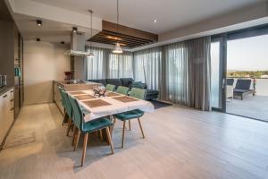 a kitchen and dining room with a table and chairs at Luxury Apartment Imperia in Krk