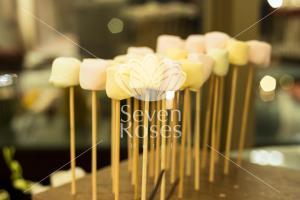 a row of marshmallows on sticks on a table at Seven Roses Hotel in Amman