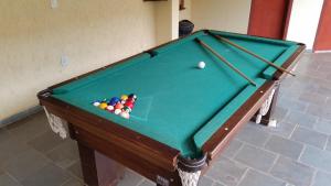 a green pool table with a ball on it at Hotel Refugio in Bonito