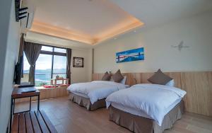 Rúm í herbergi á Yulaikung B&B