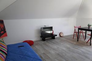 a living room with a couch and a tv and a table at Lisbon Beach Apartments 5 in Costa da Caparica +14 photos