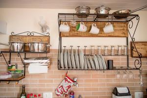 a kitchen with lots of utensils on a wall at Historic House in Rio de Janeiro +20 photos