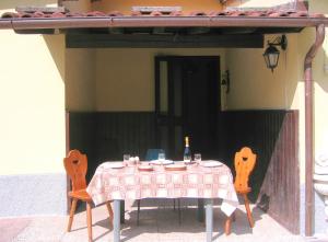 a table with two chairs and a bottle of wine on it at Villa with River Access in Cocciglia