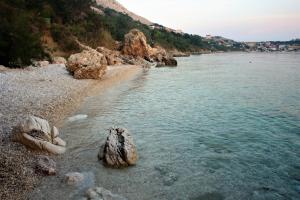 a group of rocks on the shore of a body of water at Quercus Apartment in Stara Baška