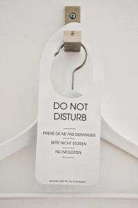 a do not disturb sign attached to a urinal at The Crown Rooms Newmarket in Newmarket