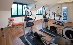 a gym with treadmills and elliptical machines at My Südstadt Bonn in Bonn