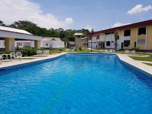 a large blue swimming pool in front of a building at Hotel Villas Kin Ha in Palenque