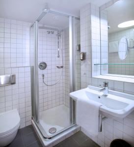 uma casa de banho com um chuveiro, um lavatório e um WC. em My Südstadt Bonn em Bonn