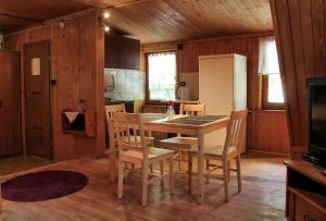 a kitchen with a table and chairs and a refrigerator at Camping Pod Krokwią in Zakopane