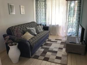 a living room with a couch and a table at Apartment near by sea in Jūrmala