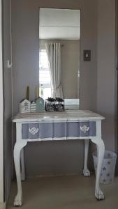 a dressing table in front of a mirror at Strandloper Apartments in Hermanus +45 photos