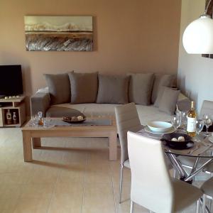 a living room with a couch and a table at Euphoria Skiathos in Skiathos