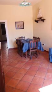 a dining room with a table and chairs at La Dimora Del Nonno Marinaio in San Nicola Arcella