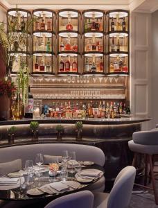 a restaurant with a table and chairs and a bar at The Connaught in London