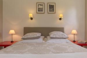 - une chambre avec un lit avec deux oreillers et deux lampes dans l'établissement Chambre d'hotes de la Vallee, à Montaure