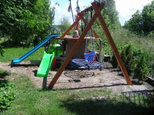 a playground with a table and a swing at Pod Kotem in Rowy