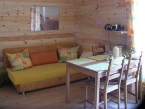a living room with a couch and a table at Pod Kotem in Rowy