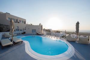 a swimming pool on the balcony of a hotel at Red Stone Villa in Oia