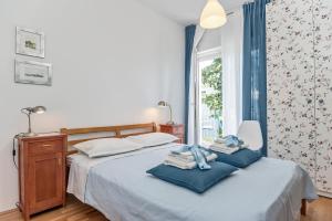 a bedroom with a bed with blue towels on it at Beachfront Apartment Mala Tereza in Split