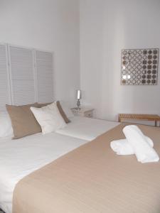 A bed or beds in a room at Santa María 12 Boutique Apartamentos