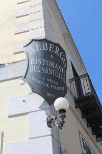 a sign for a restaurant on the side of a building at Hotel Il Santuario - Pompei in Pompei