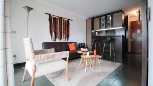 - un salon avec un canapé, une table et des chaises dans l'établissement M Montt Las Condes, à Santiago