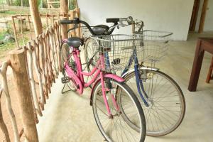 a pink bike parked next to a fence at King's Elephant Cabanas & Restaurant in Tangalle