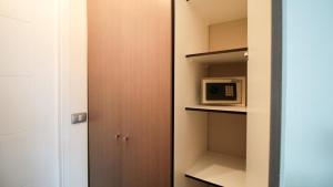 a walk in closet with a microwave in it at M Montt Las Condes in Santiago +28 photos