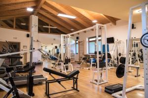 a gym with a lot of treadmills and machines at Resort Monviso in Sanfront