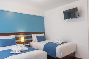 Postel nebo postele na pokoji v ubytování Wayqey Hotel