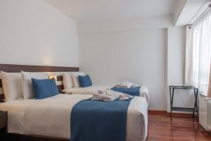Postel nebo postele na pokoji v ubytování Wayqey Hotel