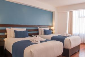 Postel nebo postele na pokoji v ubytování Wayqey Hotel