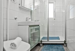 a bathroom with a toilet and a sink and a shower at Beachfront Apartment Mala Tereza in Split