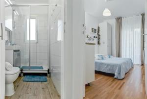 a white bathroom with a bed and a toilet at Beachfront Apartment Mala Tereza in Split