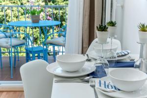 a white table with white dishes on top of it at Beachfront Apartment Mala Tereza in Split
