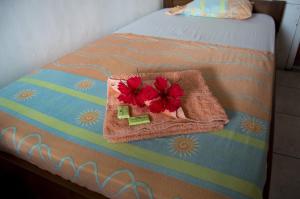a bed with towels and flowers on top of it at Hotel Sol Puntarenas in Puntarenas