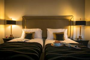 Postel nebo postele na pokoji v ubytování Keenans Boutique Hotel + 18 fotografií