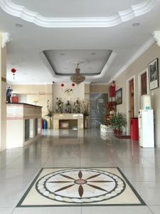 a large lobby with a large clock on the floor at Raja Inn in Miri