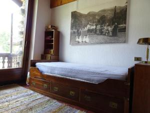 a bedroom with a bed with a picture on the wall at La Rouine - Morgex in Morgex