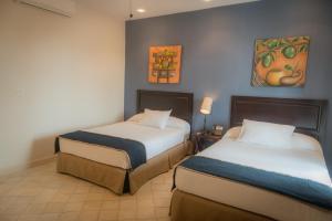 Katil atau katil-katil dalam bilik di Hotel Presidente Las Tablas