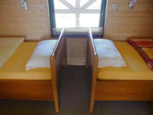 two beds in a room with a window at Ferienhaus Franziska in Kołobrzeg