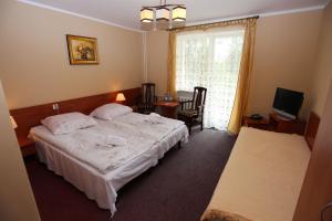 Postel nebo postele na pokoji v ubytování Hotel Kakadu